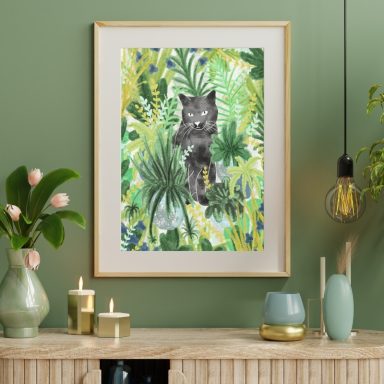 Framed artwork of a cat among green tropical plants.