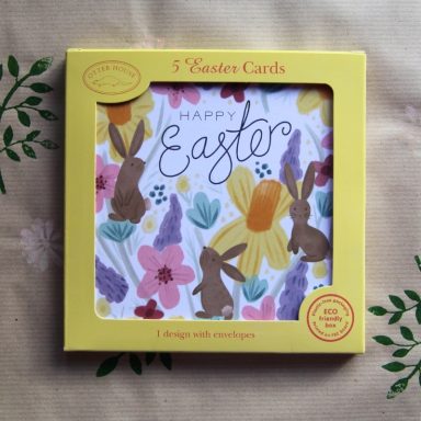 A box of Easter cards featuring bunnies and flowers on a decorative background.