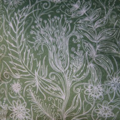 Floral and leafy patterns in white on a green background.