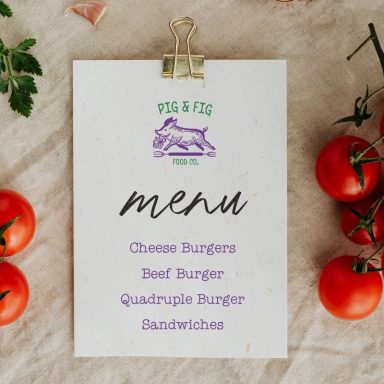 Menu featuring various burger options alongside fresh tomatoes.