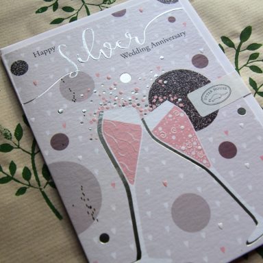 Greeting card for a silver wedding anniversary featuring pink shoes and decorative elements.